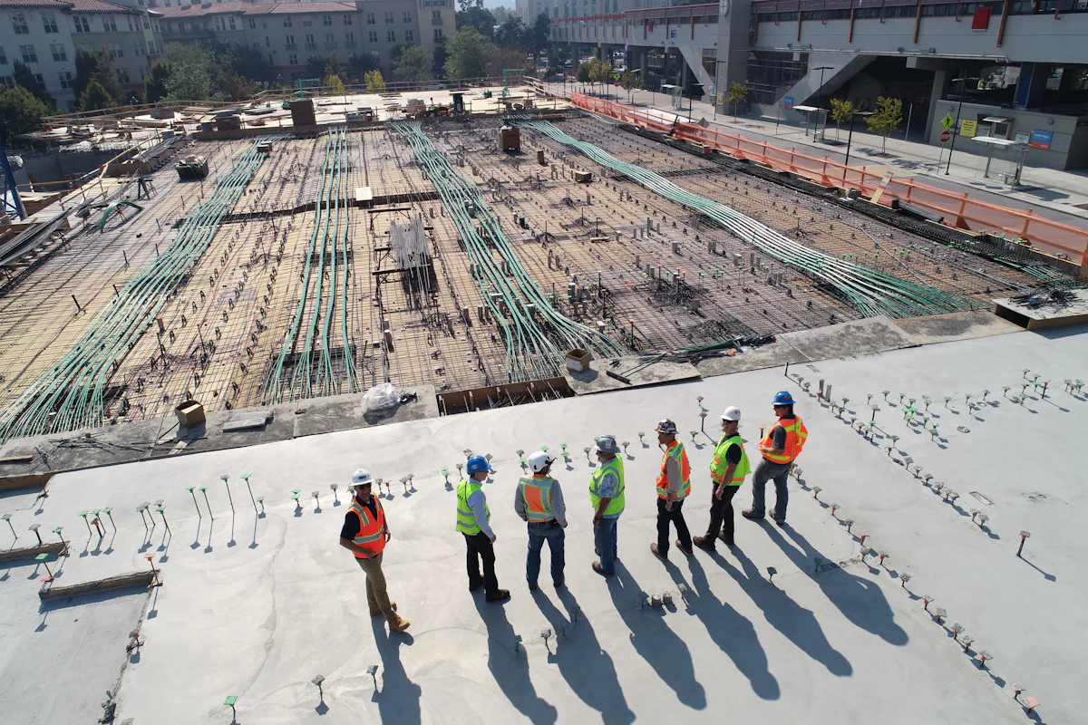 A commercial site team reviewing progress together on a construction deck
